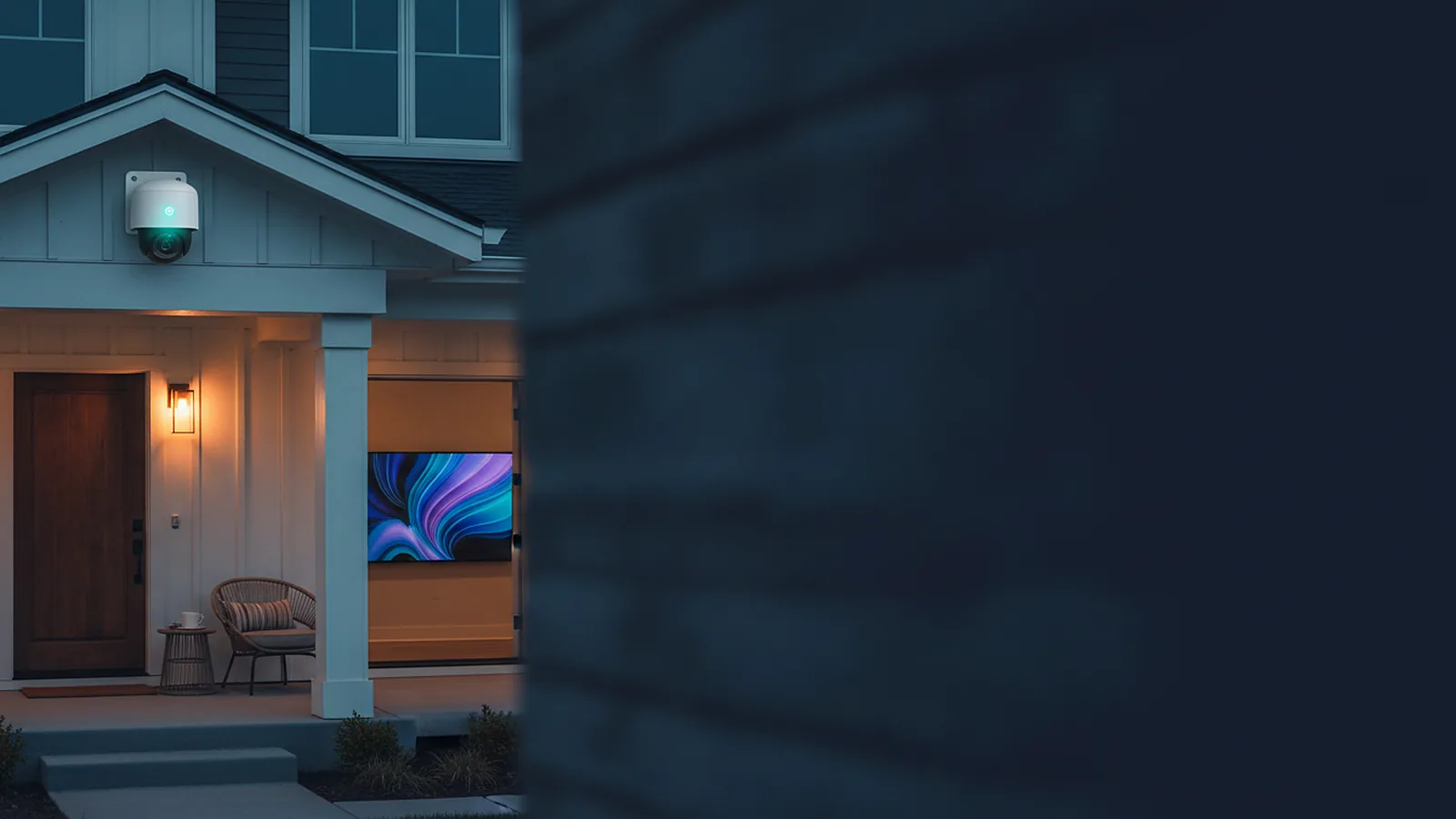 A white security camera mounted under the eave of a house at dusk over a lit front porch